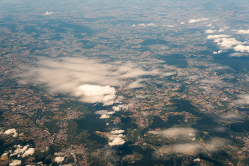 View from airplane on ground with clouds and fields