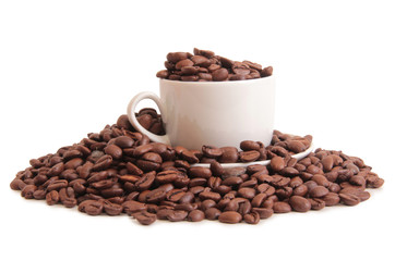 Coffee beans and a white cup on white background