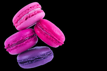 macaron on a black background of four colors, purple