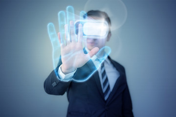 Business man wearing VR Virtual Reality goggle headset reach his hand to use fingerprint authentication and access personal data security