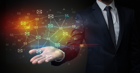 Businessman holding communication symbols