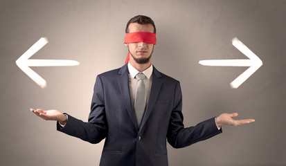 Covered eye businessman choosing direction