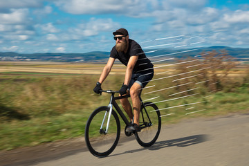 Fototapeta na wymiar Casual cyclist riding bicycle very fast