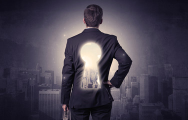 Businessman standing with keyhole on his back