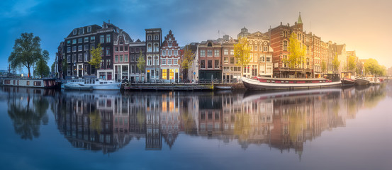 River, canals and traditional old houses Amsterdam - obrazy, fototapety, plakaty