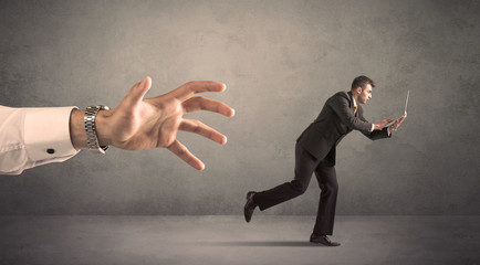 Businessman running from hand