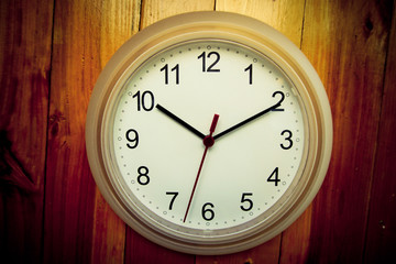 White clock on wooden wall