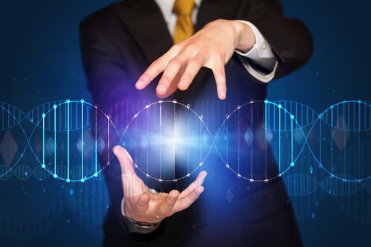 Businessman holding DNA - Powered by Adobe