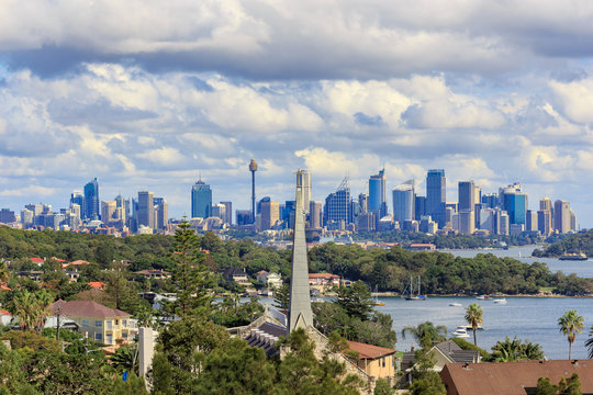 A view of Watsons Bay and the distant skycrapers of Sydney' CBD, Water with Yacht, Harbour Bridge and Cityscape in background
