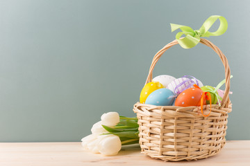Easter basket with eggs and tulips