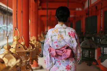 backview of Japanese woman in summer kimono(yukata) with lanterns in a Traditional Japanese building