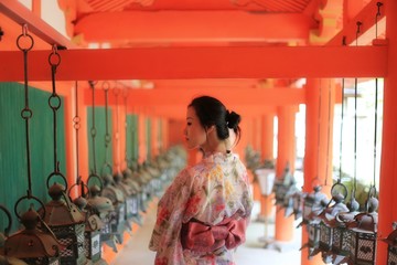 a silhouette of a young Japanese woman in summer kimono (yukata) standing in the middle of series...