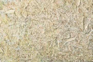 Golden painted textured plasterd cement wall. Background for text or image.