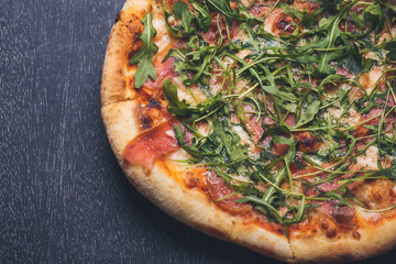 Prosciutto pizza on blackboard