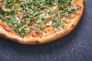 Prosciutto pizza on blackboard