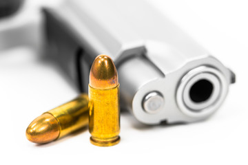 Gun and bullets on white floor