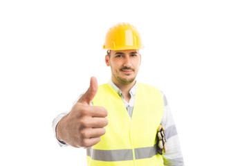 Handsome and confindent professional worker showing thumb-up gesture.