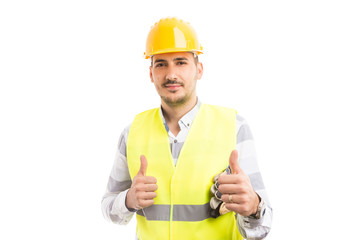 Smiling confident handsome constructor showing double like.