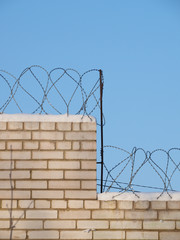 barbed wire on a brick fence