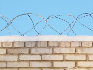 barbed wire on a brick fence