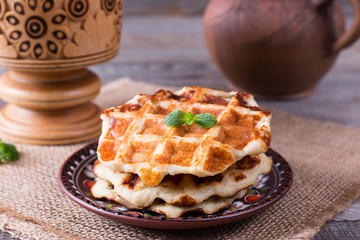Honey pouring on a fresh waffles. Breakfast with Belgian waffles