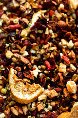Mix tea karkade with dried fruits and flowers. Fruit tea background and texture. Top view. Food background. Organic healthy herbal leaves, detox tea.