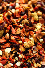 Mix tea karkade with dried fruits and flowers. Fruit tea background and texture. Top view. Food background. Organic healthy herbal leaves, detox tea.