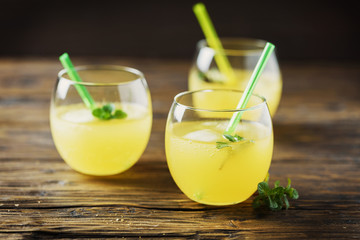 Glasses of orange cocktails with ice and mint