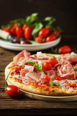 Italian pizza with mozzarella, tomato and bacon