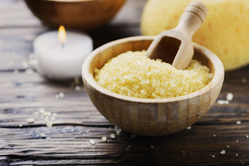 Concept of spa therapy and wellness with yellow salt and candles