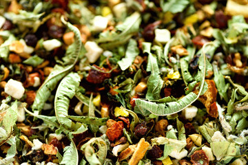 Organic dry chamomile and linden herbal tea. Food background. Organic healthy herbal leaves. Texture of green detox tea with dried fruits.