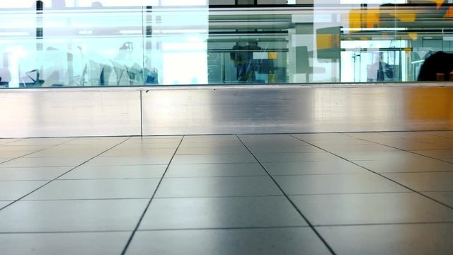 Slightly defocused video of people walking line to the departure counter in airport