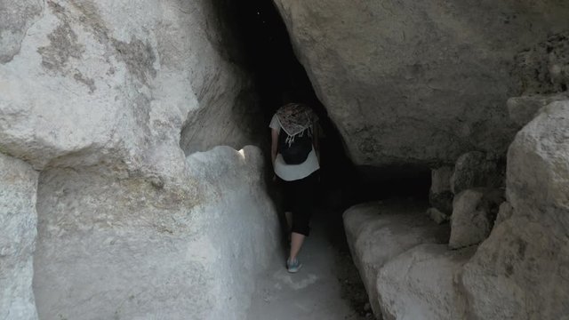 Young girl walks in cave monastery Vardzia - Georgia
