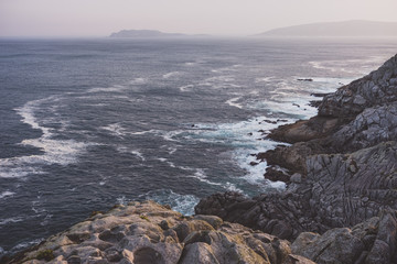 Summer Atlantic Ocean rocky coastline panorama, Biscay Bay, Spain. Misty view.