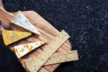 Dark Food - Blue Stiltons and Blue Shropshire cheeses on an olive wood board