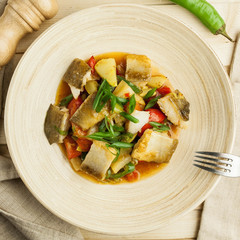 vegetable stew with pieces of fish in a bamboo dish