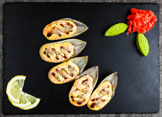 Baked mussels with cheese on a stone board - 193102106