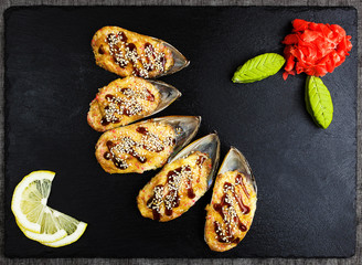 Baked mussels with cheese on a stone board - 193102115