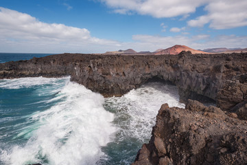 Fototapeta premium Lanzarote landscape. Los Hervideros coastline, lava caves, cliffs and wavy ocean. No people appears in the scene.