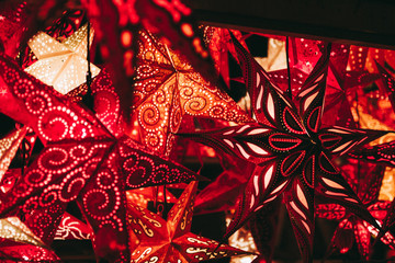 beautiful gipsy stars lamps and christmas ball lights at market stall in shades of red