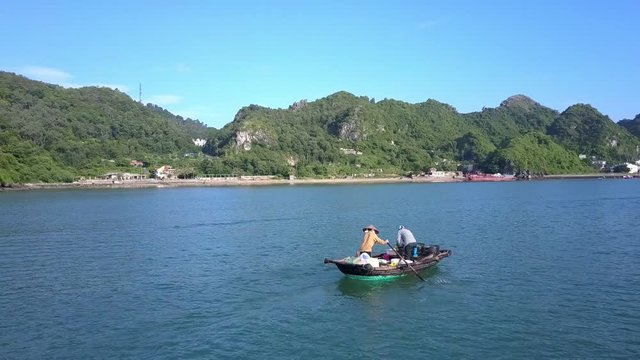 Drone Shows Asian Fishermen in Wooden Boat and Mountain