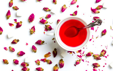 Rose tea in cups on white background