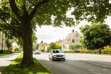 Beautiful  landscape with car on the road. Suburb life. Travel by car 