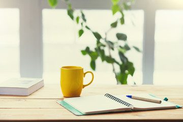 workplace, wooden table next to a large window