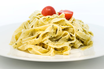 Pasta with pesto sauce and nuts on a the table