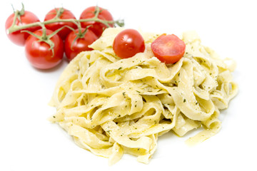Pasta with pesto sauce and nuts on a the table