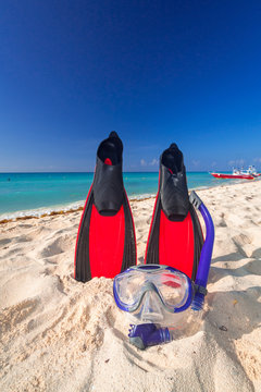 Snorkeling fins and mask on the tropical beach of Mexico
