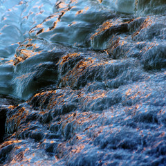 Natural, colorful ice at winter morning at the rapids of Vieremä, Forssa, Finland. 