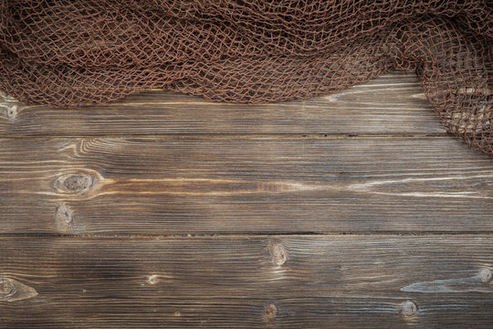 Wooden background with old fishing net.