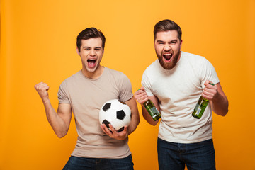 Portrait of a two happy young men holding beer bottles